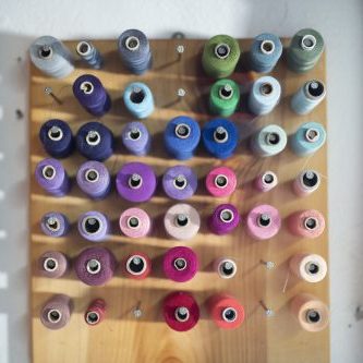 Detail of small tailoring studio, pallete of colors threads.